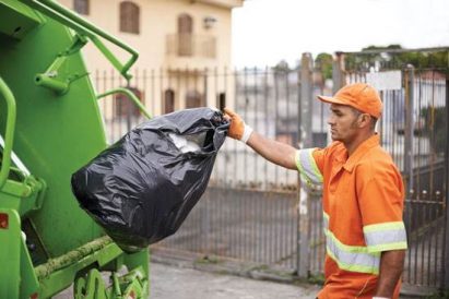 Heart of the Home: Woman Shows Appreciation for Men on Garbage Truck Image